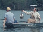 People Fishing on a Lake by KAIT-TV