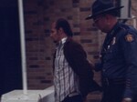 State Police Escort Hutcherson to County Jail by KAIT-TV