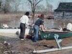 Men Assess Flood Damage