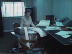 K8 Films School Board Employee as She Works on Paperwork